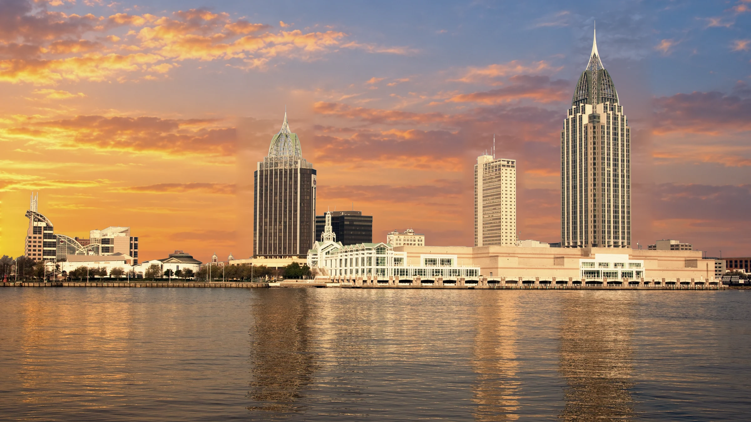 Mobile, Alabama waterfront with the original 2010 skyline architecture, edited with a golden sunset sky and color treatment