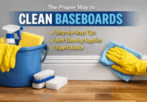 Cleaning baseboards with a microfiber cloth and household cleaning supplies.